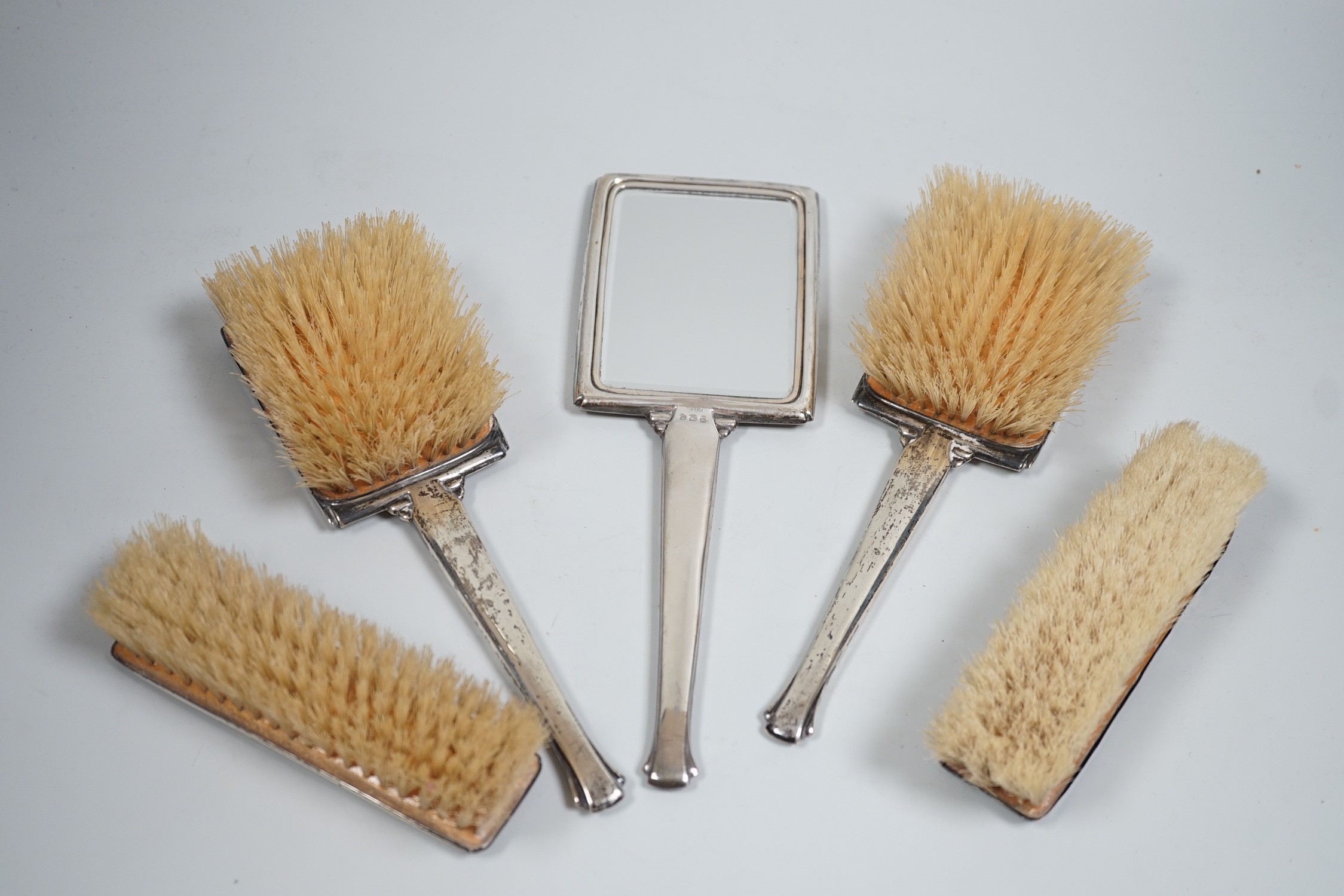 A 1930's Art Deco silver mounted five piece brush and mirror set, Birmingham, 1937.